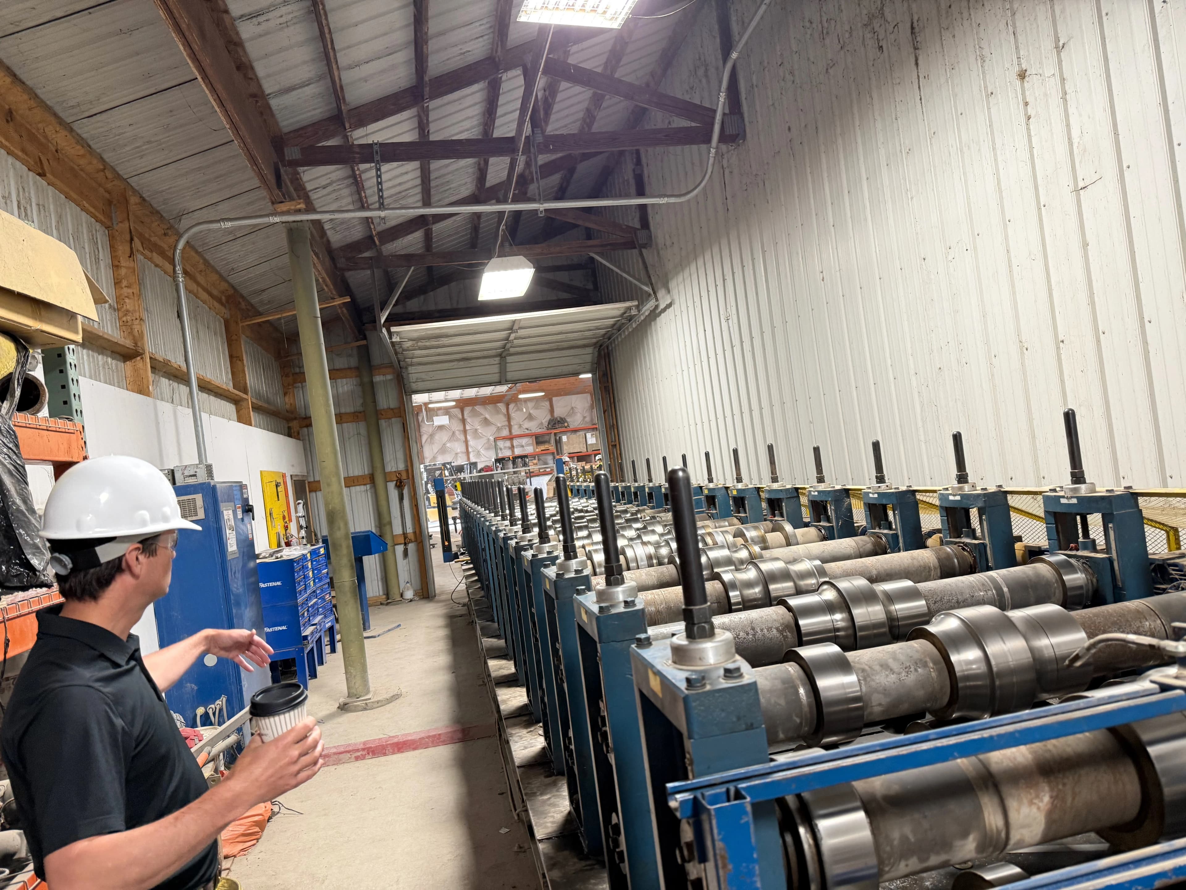 A shop-floor walkthrough beside a roll-forming line